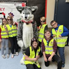 Joy and Kindness club group photo with Husky mascot